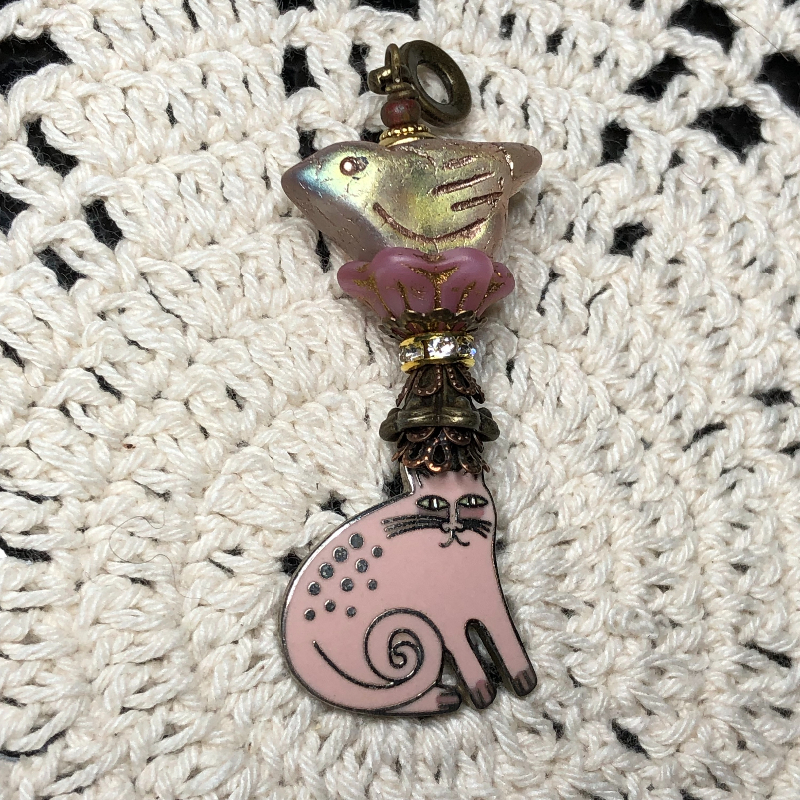 pink enameled cat, glowing bird necklace pendant