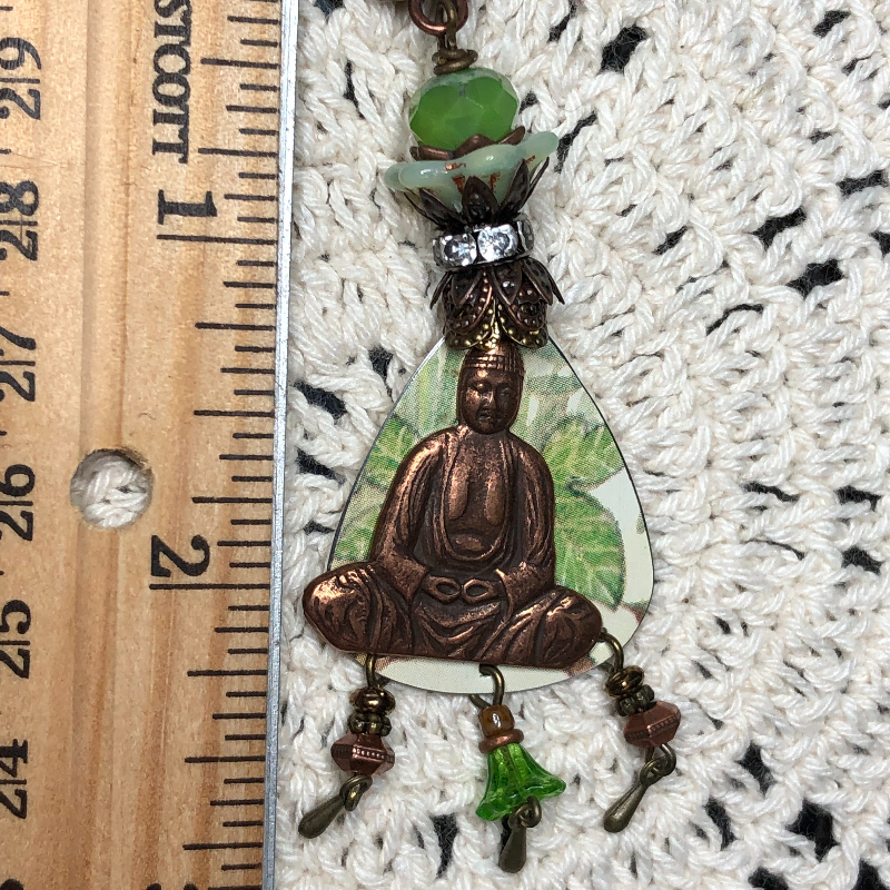 buddha in the tropical forest, vintage tin necklace pendant