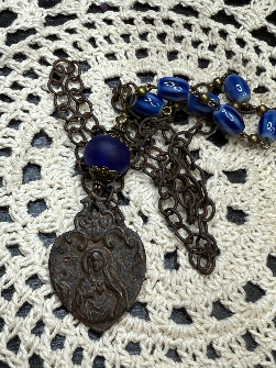 rustic, religious figure blue glass necklace