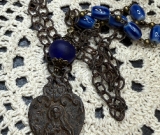 rustic, religious figure blue glass necklace